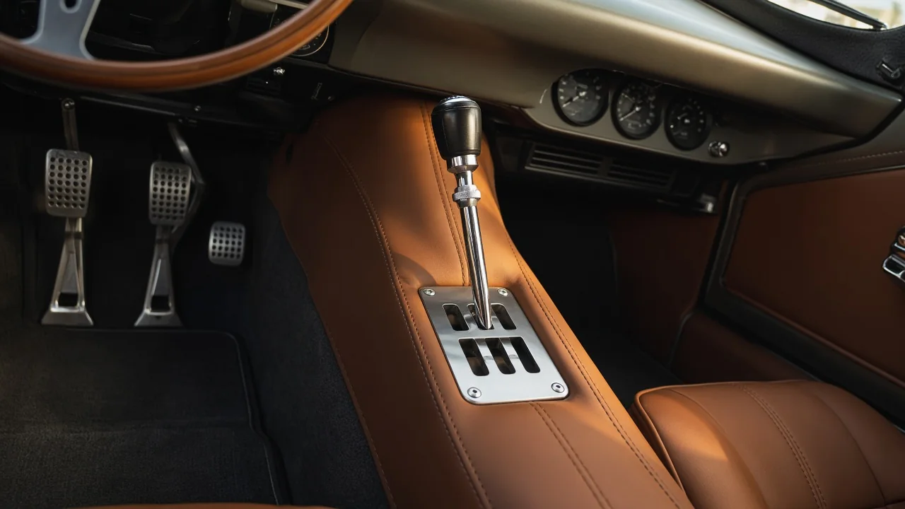 Ferrari-style exposed metal shift gate with a manual gear lever and three pedals
