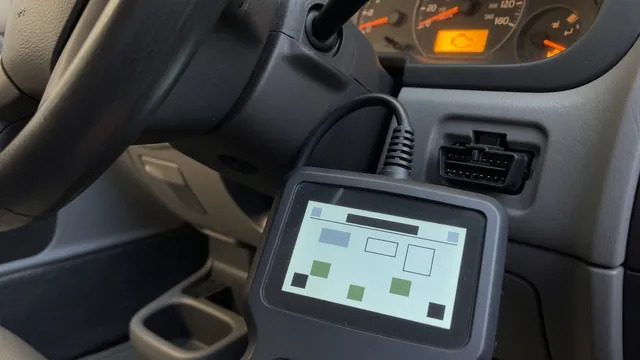OBD-II scan tool connected under a car dashboard with the check engine light on, used to read a P1624 trouble code