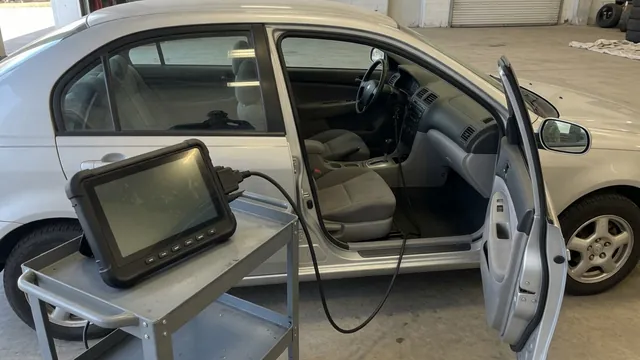 Diagnostic scanner displaying P1289 beside a parked vehicle with its engine off