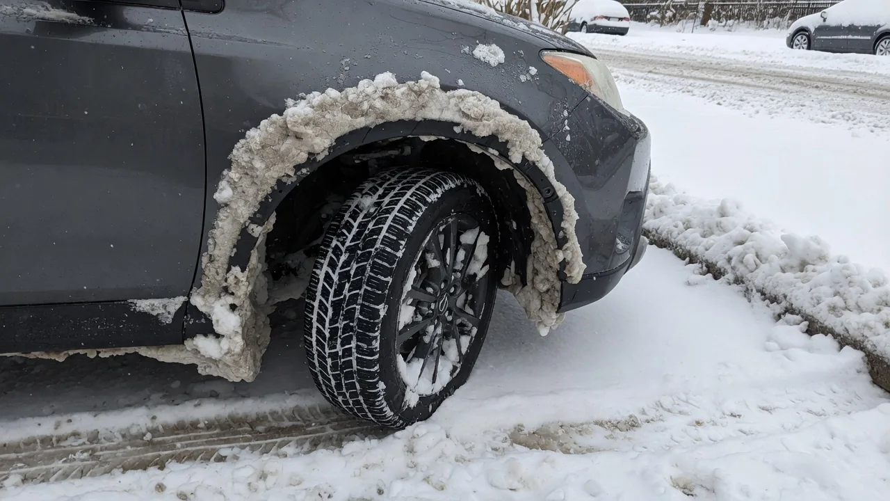 Automotive scene illustrating Why Does Snow Stick in Wheel Wells