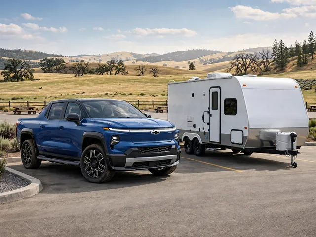 Chevrolet Silverado EV parked beside a travel trailer at a scenic highway rest area