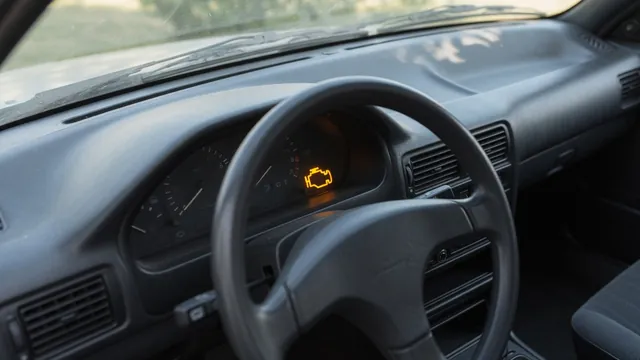 Infiniti Q50 dashboard with an illuminated check engine warning light