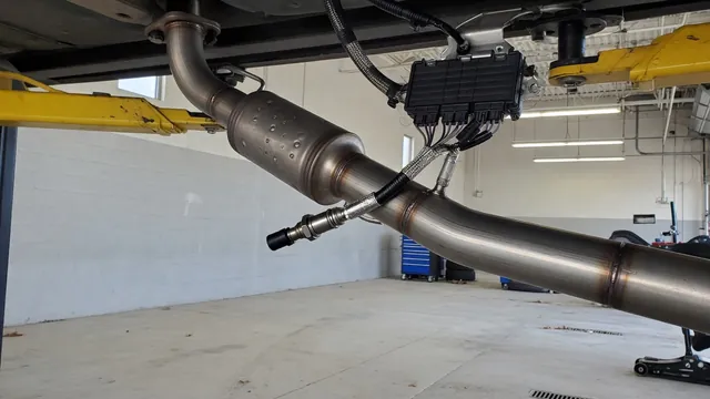 NOx sensor wiring and control module beside a diesel exhaust assembly in a service bay