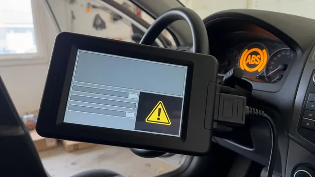 Handheld scan tool plugged into a car's diagnostic port, with a chassis warning light glowing on the dashboard