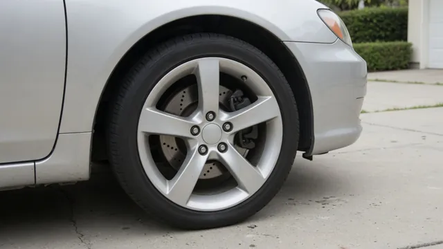 Brake rotor and caliper visible through a parked car’s wheel