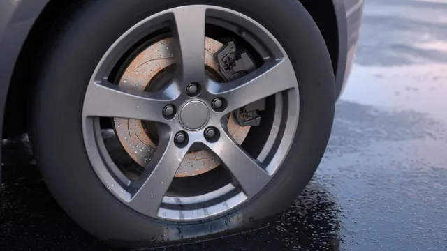 Close-up of a brake rotor and caliper with moisture droplets visible through a parked car’s wheel.