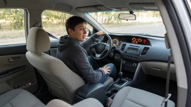 Driver observing dashboard warning lights in a parked car after the engine stalls shortly after starting