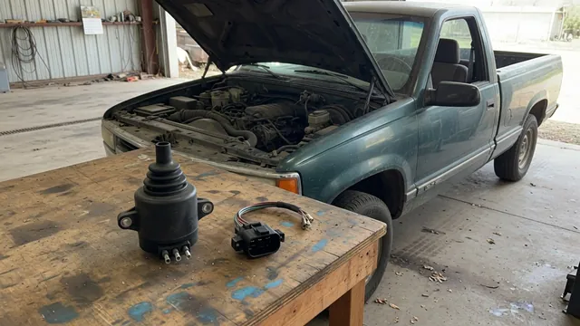 Ignition coil and electrical connector beside an open Chevrolet Silverado engine bay