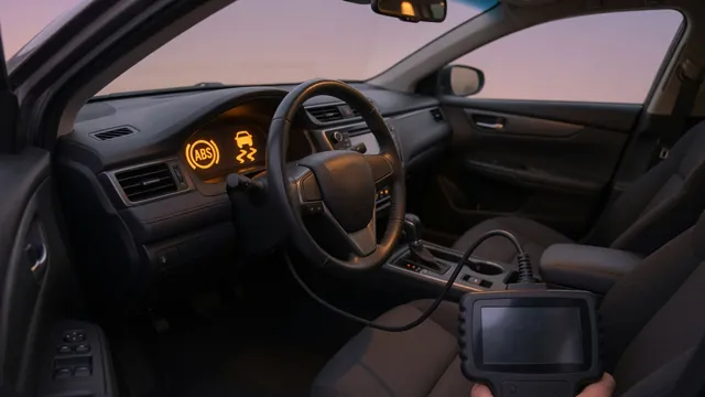 Dashboard with ABS and traction control warning lights on beside a connected scan tool reading a chassis code