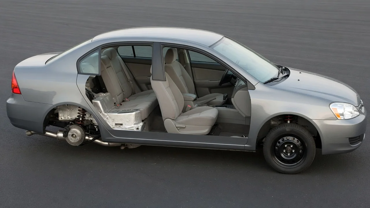 Parked car with highlighted cabin, exhaust heat shield, and suspension areas where rattles may originate