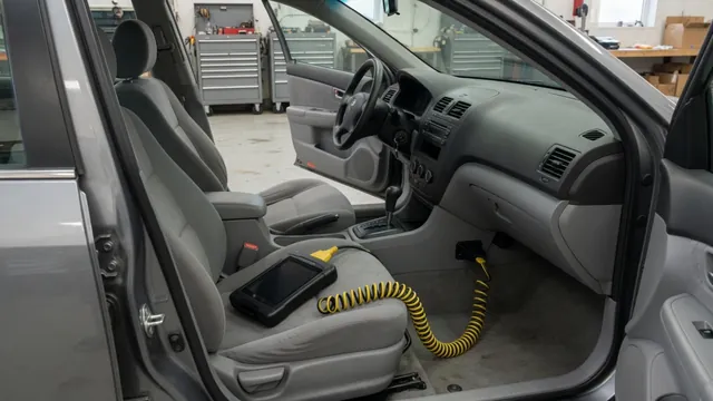 Diagnostic scanner connected beneath a vehicle dashboard during a trouble-code check