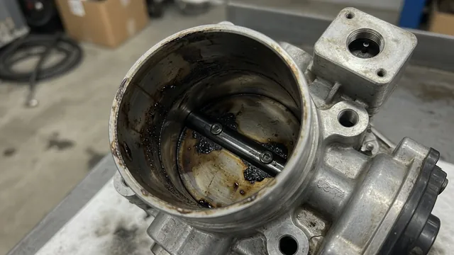 Dark deposits around the throttle plate edge and bore of an engine throttle body