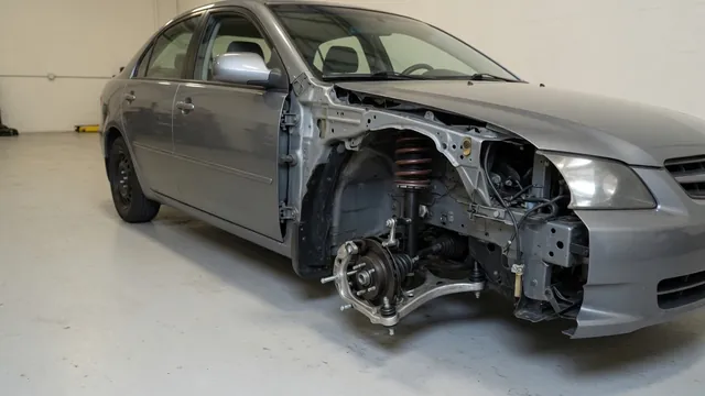 Car wheel and suspension assembly showing a bushing, ball joint, sway bar link and shock absorber