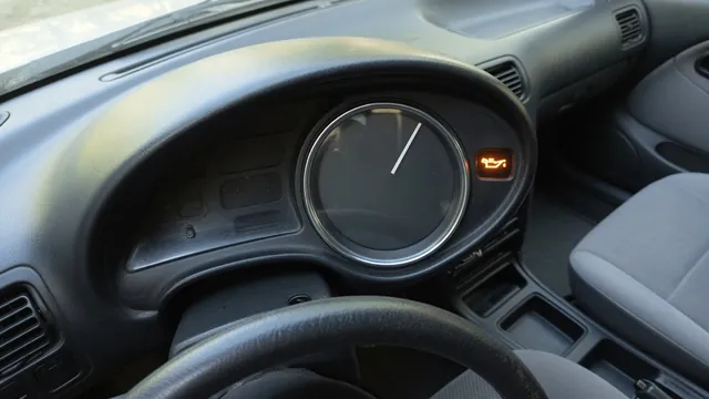 Dashboard oil pressure gauge and illuminated oil warning symbol with the vehicle parked