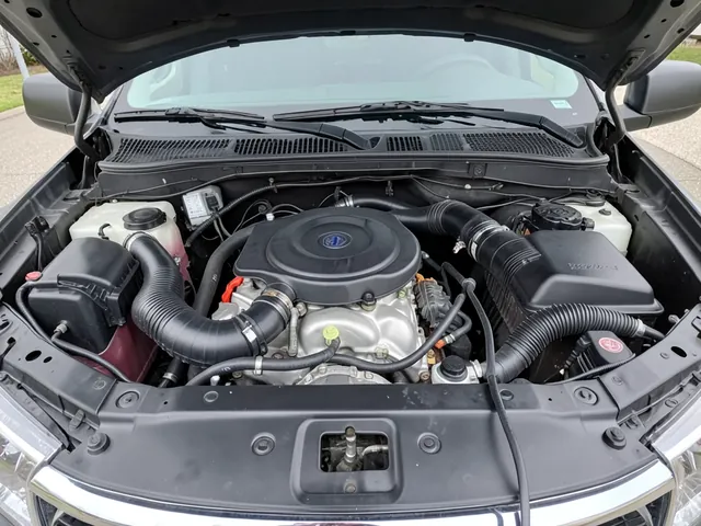 Ford truck engine bay with crankcase ventilation hoses visible during an engine-off inspection