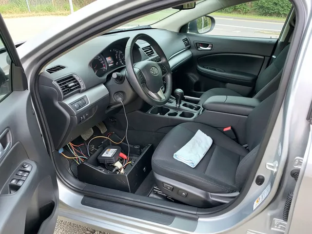 Toyota cabin air filter beside an open glove compartment with the filter access cover visible