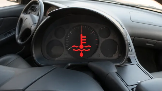 Coolant temperature warning illuminated on a vehicle dashboard with the vehicle safely parked.
