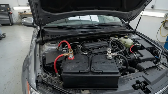 Open car hood showing a replacement battery and terminal connections during a no-start inspection