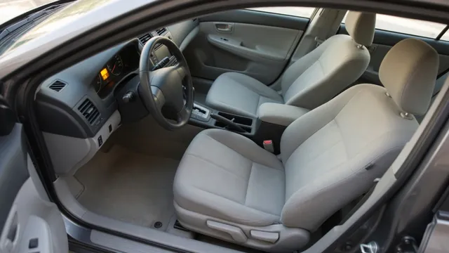 Front passenger seat inside a car, with an airbag warning light lit on the instrument cluster behind it