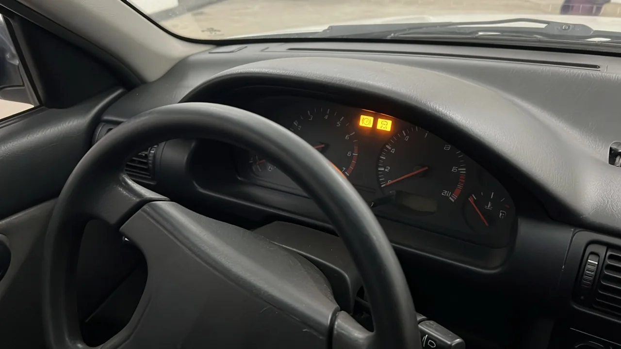 ABS and stability warning indicators illuminated on a vehicle dashboard while parked