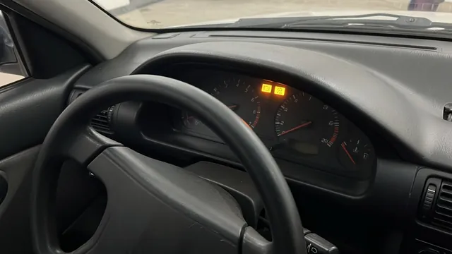 ABS and stability warning indicators illuminated on a vehicle dashboard while parked