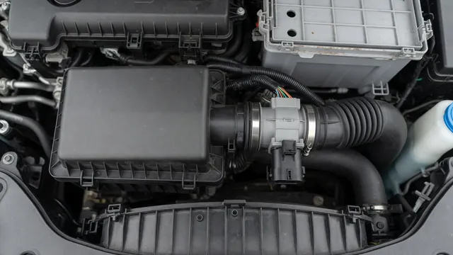 Illustration of an intake air duct and mass air flow sensor in a Nissan Sentra engine compartment