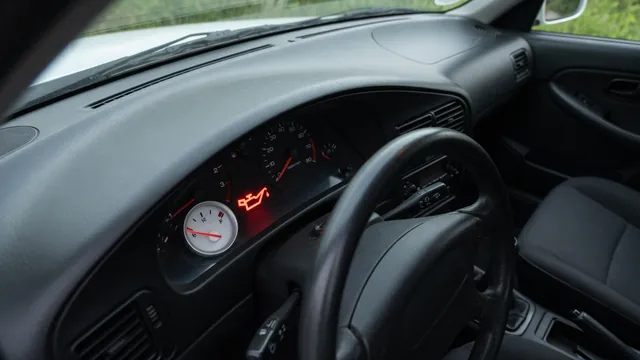 Dashboard oil pressure gauge near its low end with an illuminated oil warning symbol