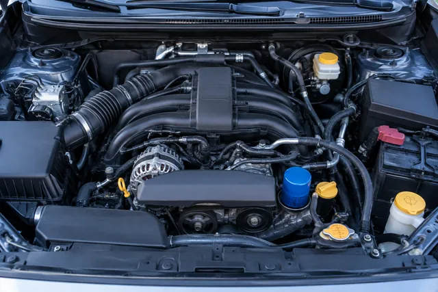 Illustration of a top-mounted spin-on oil filter in a Subaru boxer engine bay