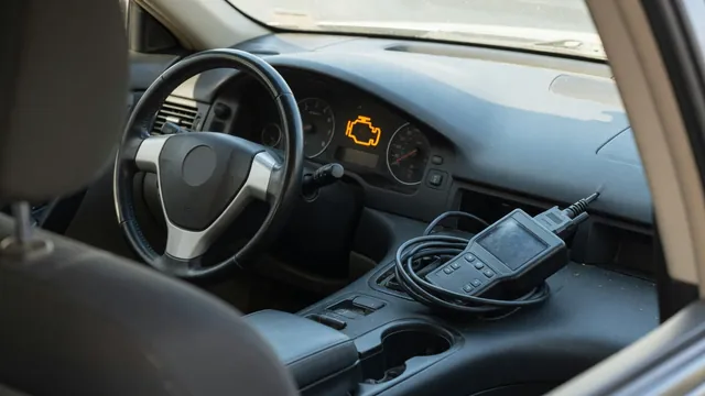 Illuminated check engine symbol on a dashboard with a diagnostic scanner nearby