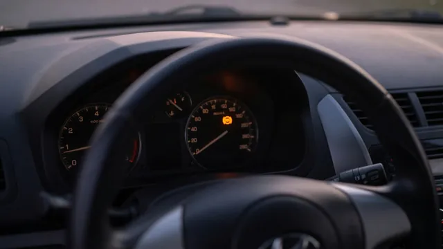 Amber ABS warning light on in a compact car's instrument cluster