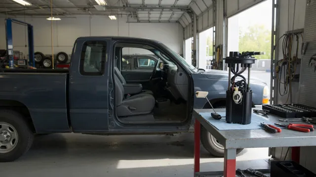 Ford F-150 parked in a service bay with a fuel pump module on a nearby workbench