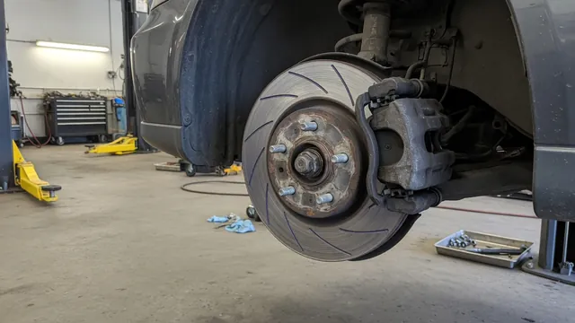 Close-up of a brake rotor and caliper with visible scoring on the rotor surface