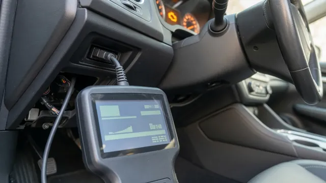 OBD-II scan tool connected under a car dashboard to read a P1612 trouble code