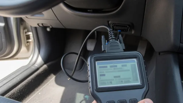 OBD-II scan tool connected under a car dashboard, showing a diagnostic trouble code reading