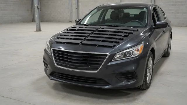 Front grille of a parked vehicle showing active grille shutter louvers behind the grille