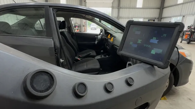 Dashboard driver assistance warning with a diagnostic scanner and visible bumper sensors