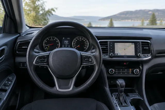 Car dashboard showing a total odometer reading and a separate Trip A mileage display