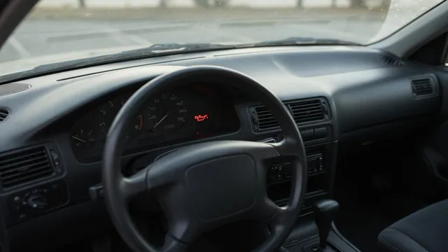 Illuminated oil pressure warning symbol on a parked vehicle’s dashboard with the engine switched off