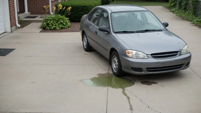 Small coolant puddle beneath the front of a parked car with its engine off