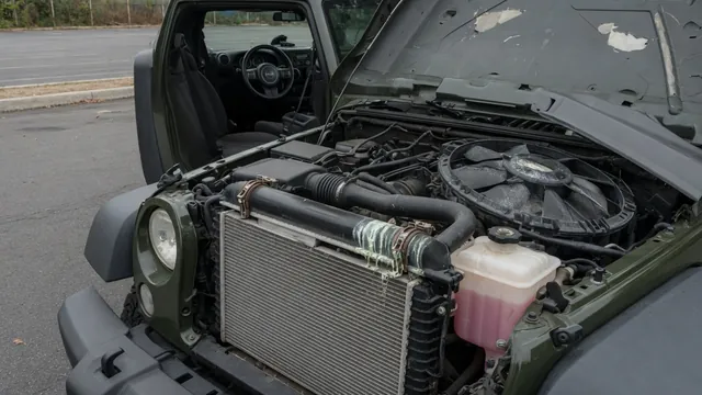 Jeep Wrangler JK radiator area with coolant residue near a hose connection