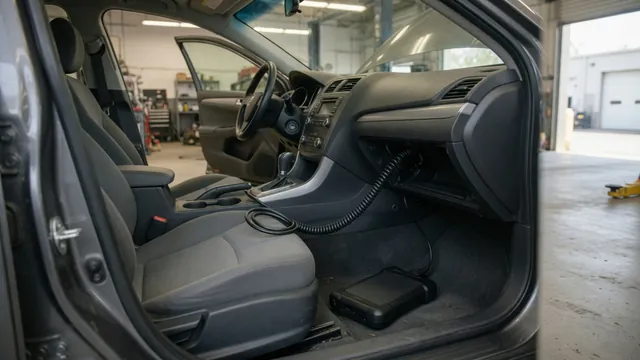 Diagnostic scanner connected inside a parked vehicle during an engine fault inspection