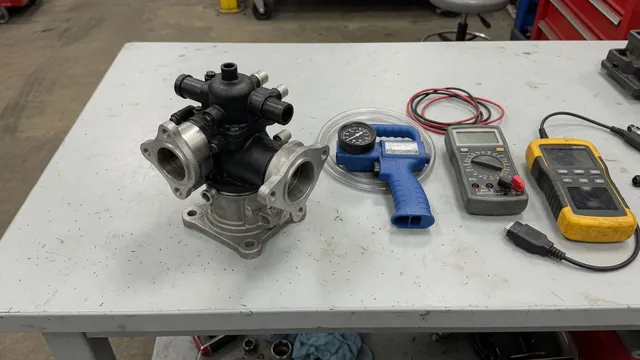 EGR valve on a clean workbench beside a hand vacuum pump, digital multimeter, and automotive scan tool