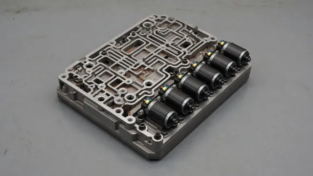 Illustration of transmission solenoids mounted on a valve body with hydraulic passages visible