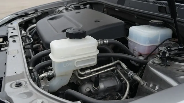 Brake fluid reservoir with MIN and MAX level markings visible through its translucent wall