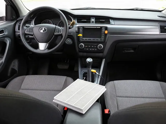 Car dashboard vents with a soft detailing brush, microfiber cloth, and cabin air filter nearby