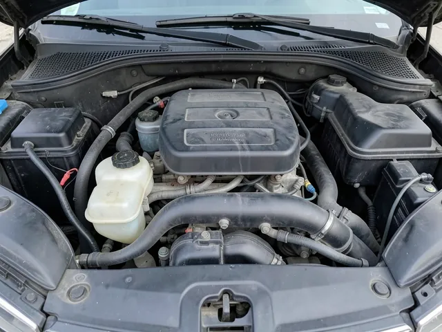 Coolant reservoir with cold-level markings visible in an engine bay