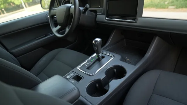 Automatic transmission selector in Park beside an illuminated gear position display