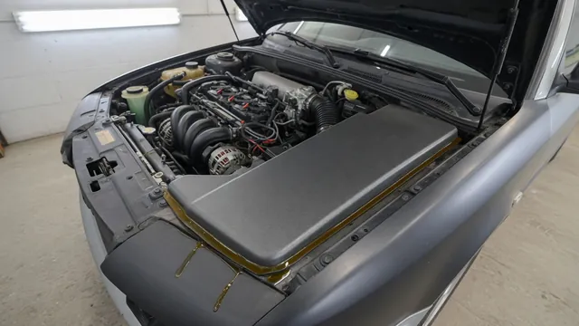 Oil residue along a valve cover gasket seam on an engine with the hood open