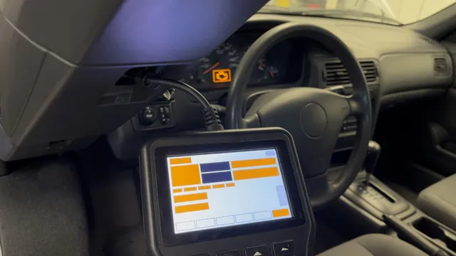 OBD-II scan tool connected under a car dashboard with the check engine light on