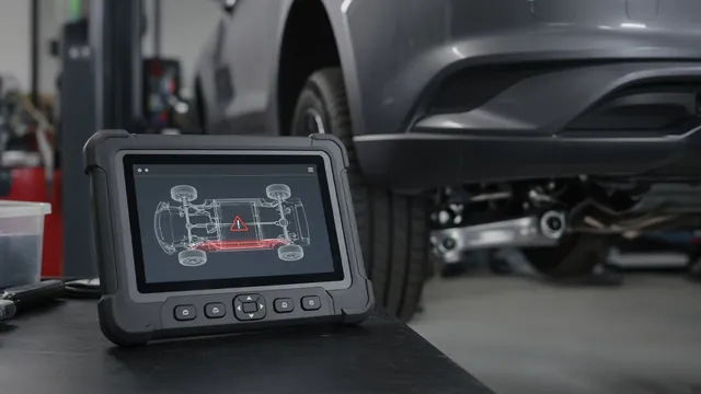 Diagnostic scan tool beside a vehicle with a chassis fault report on its screen